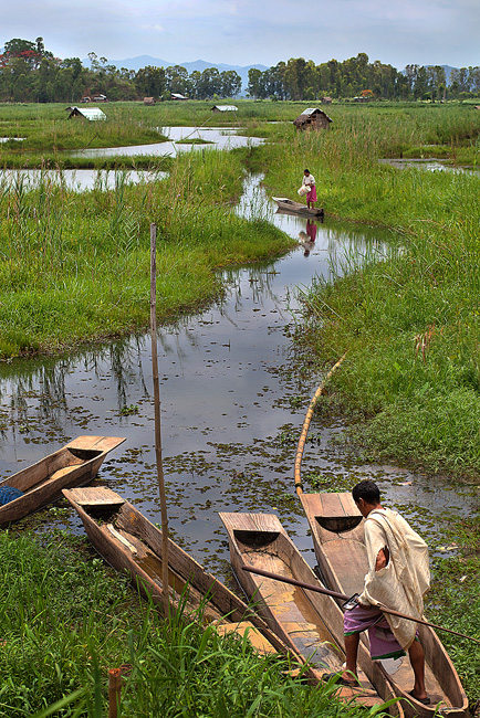 Life At Loktak Lake, Artwork by Rushi Pixelkeeda. Loktak lake is a made up of floating biomass. The eco system is built around the lake. 
Humans also have adopted their lifestyle to suit the eco system. 
From huts build on floating grass, to boats for transport.. 5D mark II. photoshop