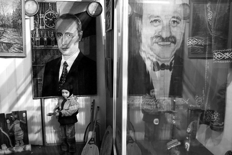 Field Of Miracles, photography by Bochkarev Mikhail. I made photo in the museum of very popular russian TV show "Field of miracles" in Allrussian Exhibition Center in Moscow. It is used to every participant of show to leave a present for a museum. Painting with V. Putin reflects in painting with the show presenter Leonid Yakubovich. Pentax k10D, 18-55 DA. Digital. In People, Everyday, City life