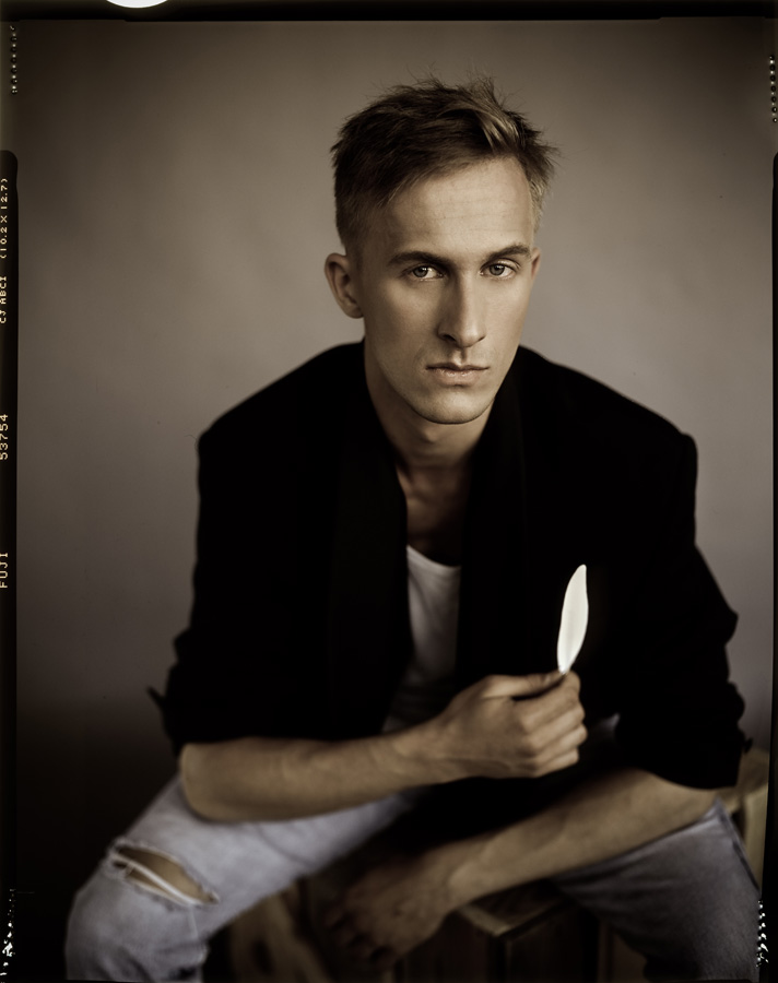 Man with Feather, photography by Piotr Biegaj. Graflex. Fuji Velvia 50. In People, Portrait