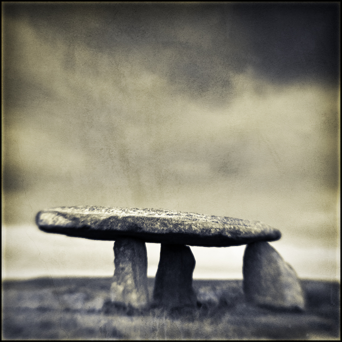 Lanyon Quoit, photography by Mark Sadlier. Penwith in Cornwall has the highest concentration of prehistoric monuments in England. Most of them stand in remote places high on the open moors.

This is what remains of a burial site dating from 5 - 6,000 years ago. The covering earth mound has long since gone leaving the chamber stones exposed.

The cap stone is around 2m high & weighs about 13.7 metric tons.

It may just be a pile of stones but still they are places of mystery & wonder.. Homemade lens. In Construction, Edifice, Monument
