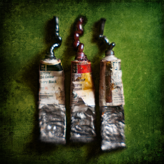 Black, red & brown, photography by Mark Sadlier. These tubes of oil paint belonged to my partners grandfather so conceivably they may be older than me. He painted landscapes I'm told & the colours seem right for that; the tubes are made of a wonderfully soft aluminium & the paint is still soft after all these years.. Homemare lens & +2 close up lens.. Lit with a Speedlite. In Object, Still life