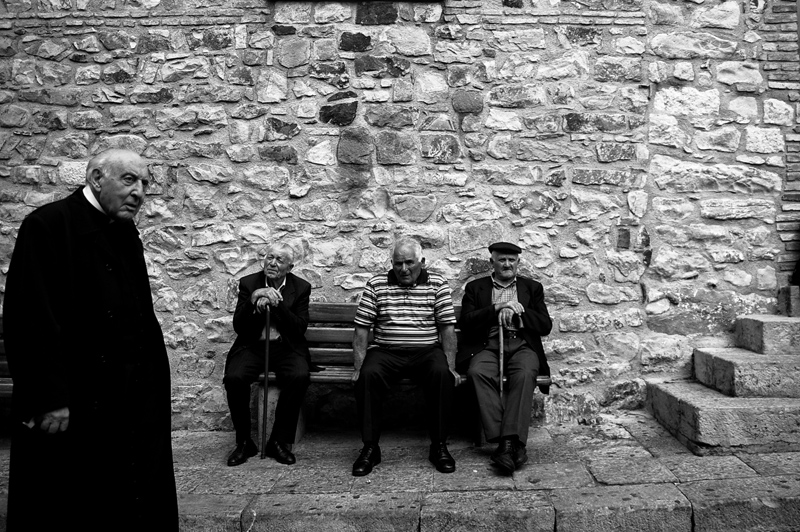 Three old men and a priest in Geraci Siculo, photography by Piotr P?dziszewski. In People, Everyday, City life