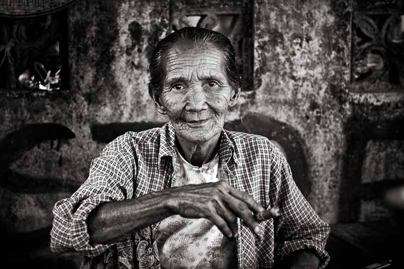 Myanmar : Woman Smoking In The Street, photography by Olivier Borson. n. digital. In People, Portrait
