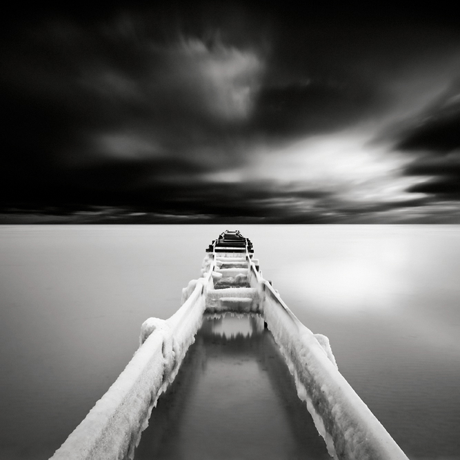 Pointer, photography by Maria Str&ouml;mvik. The icy skeleton of a small wooden pier in the Baltic Sea. This type of composition has been done a million times before, and yet I like it...  :-). Nikon D3. Very long exposure. In Nature, Scenery, Waterspace