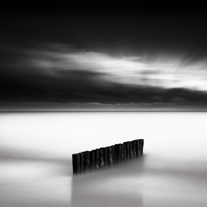 Guardian II, photography by Maria Str&ouml;mvik. Standing there, so silently, guarding the beach from erosion... To me, it's still amazing that ten and a half minutes of changing light, clouds, waves, shadows, and reflections can produce such crazy results :-). Nikon D3. Very long exposure (632 secs). In Nature, Scenery, Waterspace