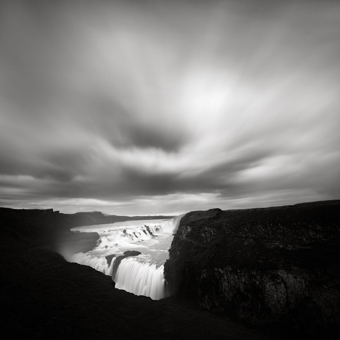 Gullfoss, photography by Maria Str&ouml;mvik. So... I was in Iceland last week, for work, but took a few days off afterwards for a little roadtrip on this fantastic island :-) 

For most part, unfortunately (from a photo perspective), the sun was all too willing to follow me wherever I went... On this evening, though, some dark clouds magically appeared just as I arrived to Gullfoss. Of course, it only took a few minutes before the rain was pouring down instead! My clothes got soaked, my camera got soaked, my camera bag (and all it's contents!) got soaked... But I was standing there, big smile on my face, with an umbrella to try to cover the camera, realising I'll take a good rainfall over sunny weather any day... At least when I have my camera with me :-). Nikon D3. Long exposure. In Nature, Scenery