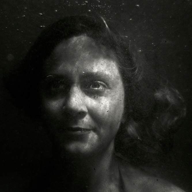 Malena, photography by Maria Str&ouml;mvik. Not sure how many more of these underwater portraits I should post, but I must admit that other than the long exposures, this is by far the most fun I've ever had with my camera. And it's been the perfect way to spend sunny summer days on the beach :-)

The portraits all come in different styles so far, mostly due to the effects of the constantly changing light under water. But also due to difficulties focusing, and difficulties in getting the flash to fire under water, and to some extent also due to trying out different ways of processing...

Model: Malena Ros&eacute;n-Sundstr&ouml;m
Location: Skan&ouml;r Harbour (Baltic Sea), Sweden.. Nikon D60, Ewa-Marine plastic bag underwater housing. In People, Portrait, Female
