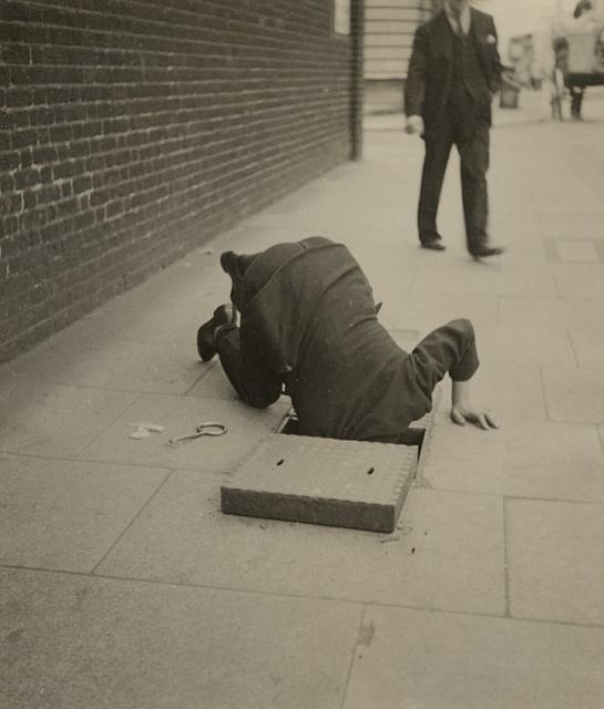 - Dora Maar, Man looking inside a sidewalk inspection door © Estate of Dora Maar / DACS 2019, All Rights Reserved