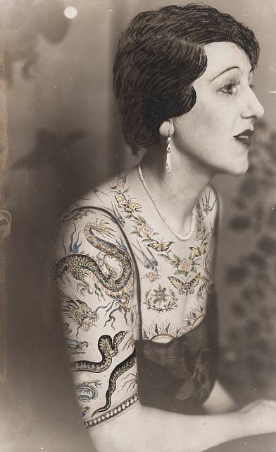 - Dora Maar, Woman sitting in profile, the bust dressed in a blouse made of tattoo patterns draw on the photography © Estate of Dora Maar / DACS 2019, All Rights Reserved